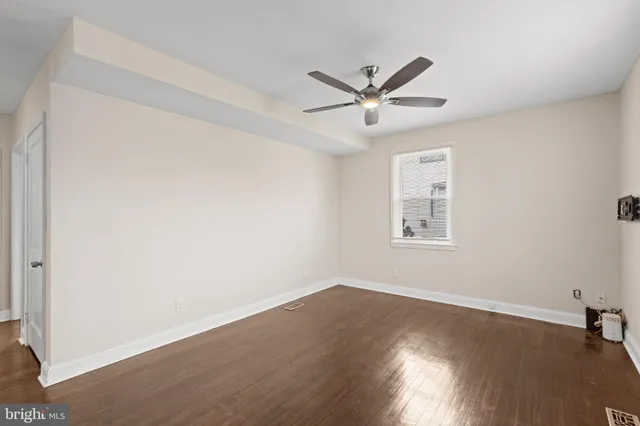 a view of a big room with wooden floor closet and windows