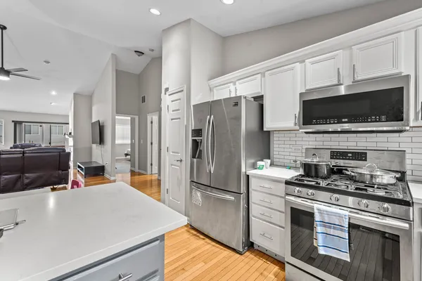 a kitchen with a refrigerator stove and microwave