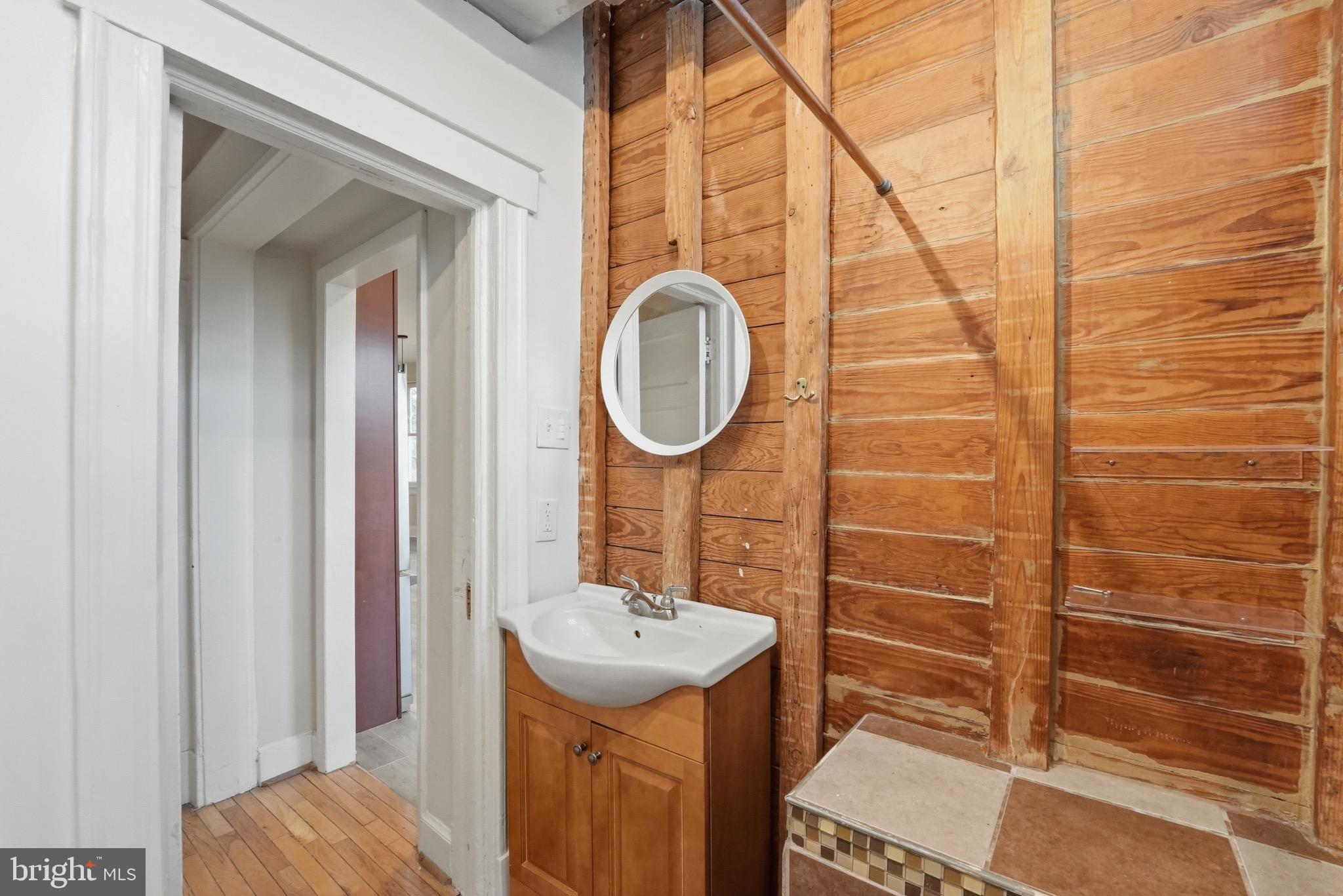 1310 Emerson Street Northwest Washington, DC 20011 - Photo 11 of 38 a bathroom with a sink a mirror and shower