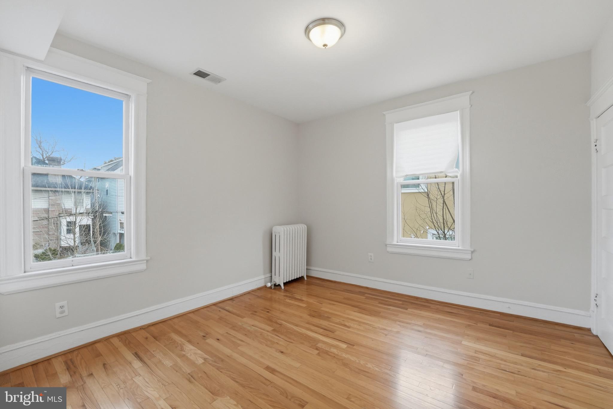 1310 Emerson Street Northwest Washington, DC 20011 - Photo 15 of 38 a view of empty room with wooden floor and fan