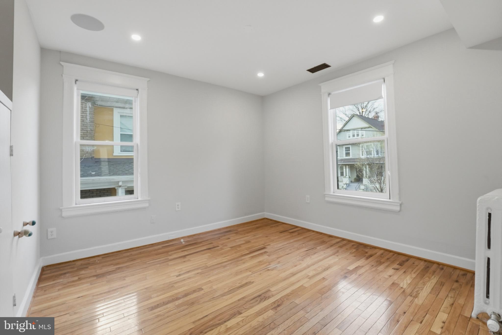1310 Emerson Street Northwest Washington, DC 20011 - Photo 17 of 38 a view of empty room with wooden floor and fan
