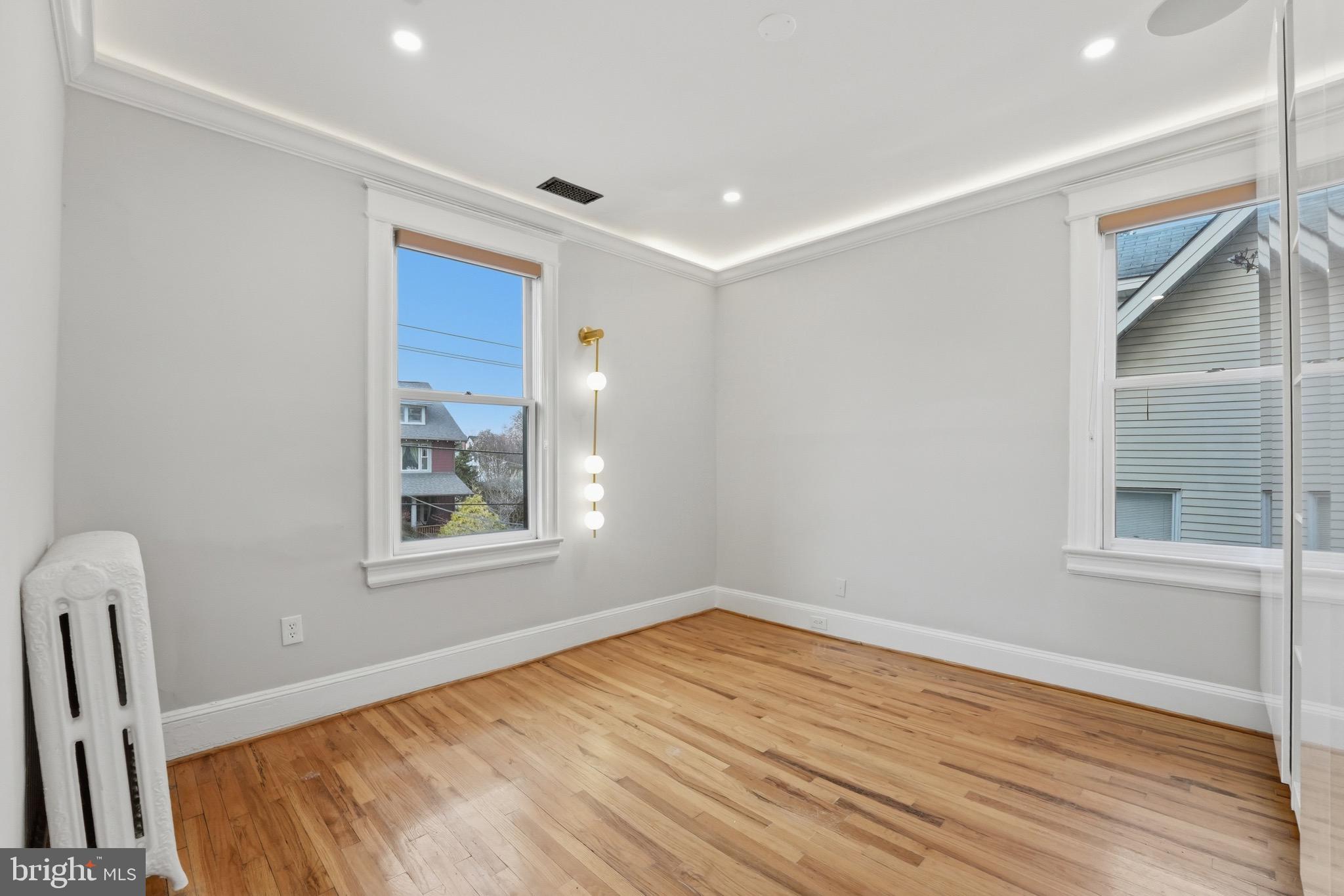 1310 Emerson Street Northwest Washington, DC 20011 - Photo 21 of 38 a view of empty room with wooden floor and fan