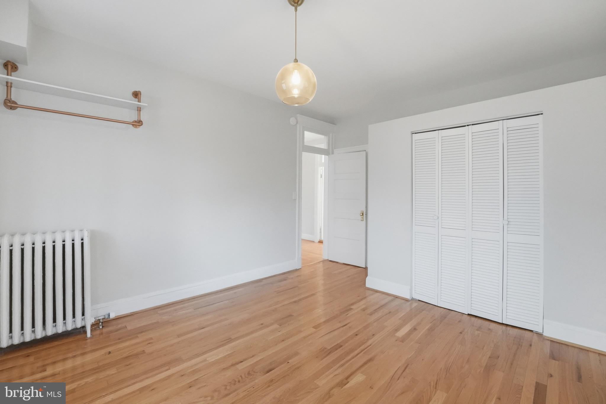 1310 Emerson Street Northwest Washington, DC 20011 - Photo 24 of 38 a view of an empty room with wooden floor and a window