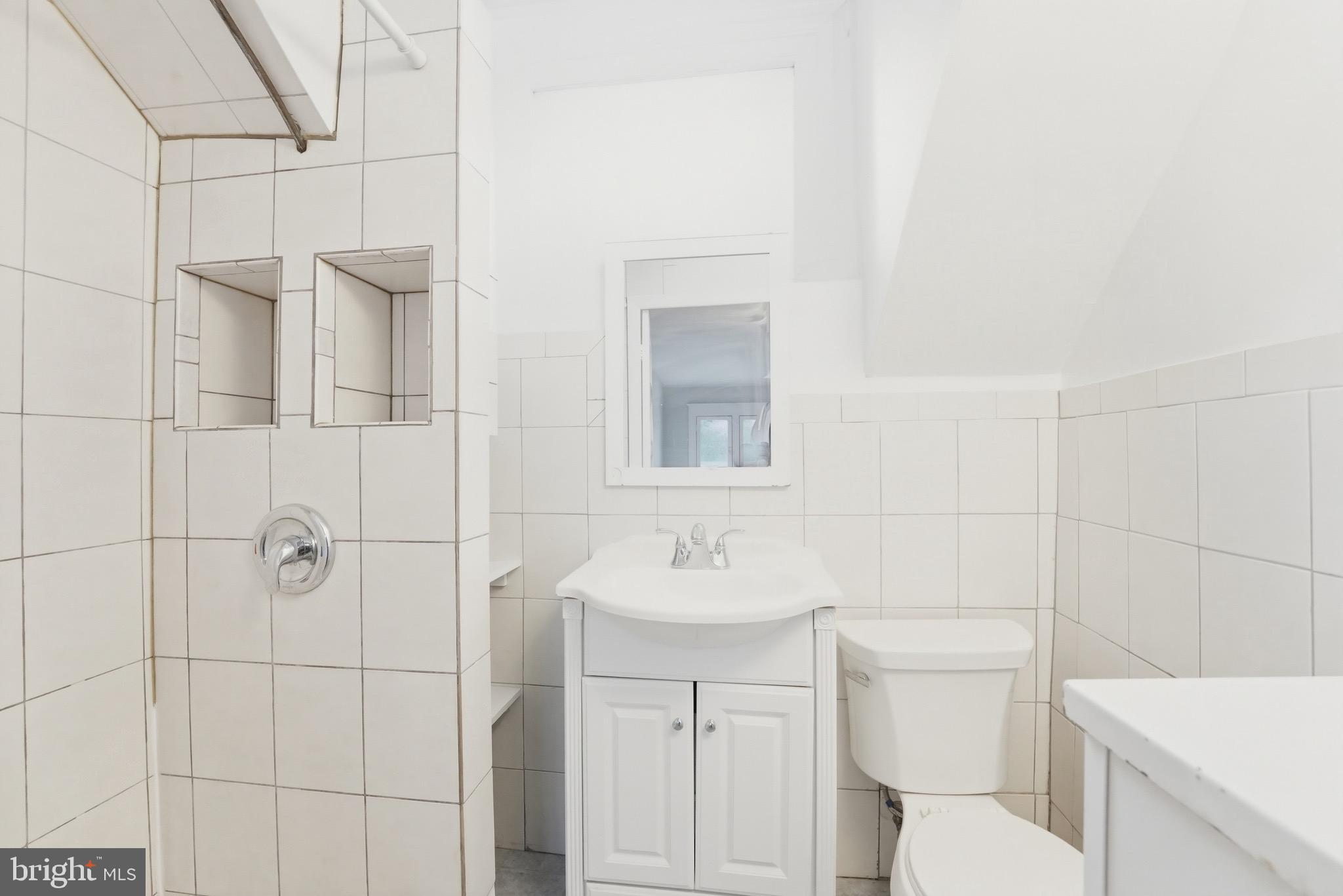 1310 Emerson Street Northwest Washington, DC 20011 - Photo 30 of 38 a bathroom with a toilet sink and shower