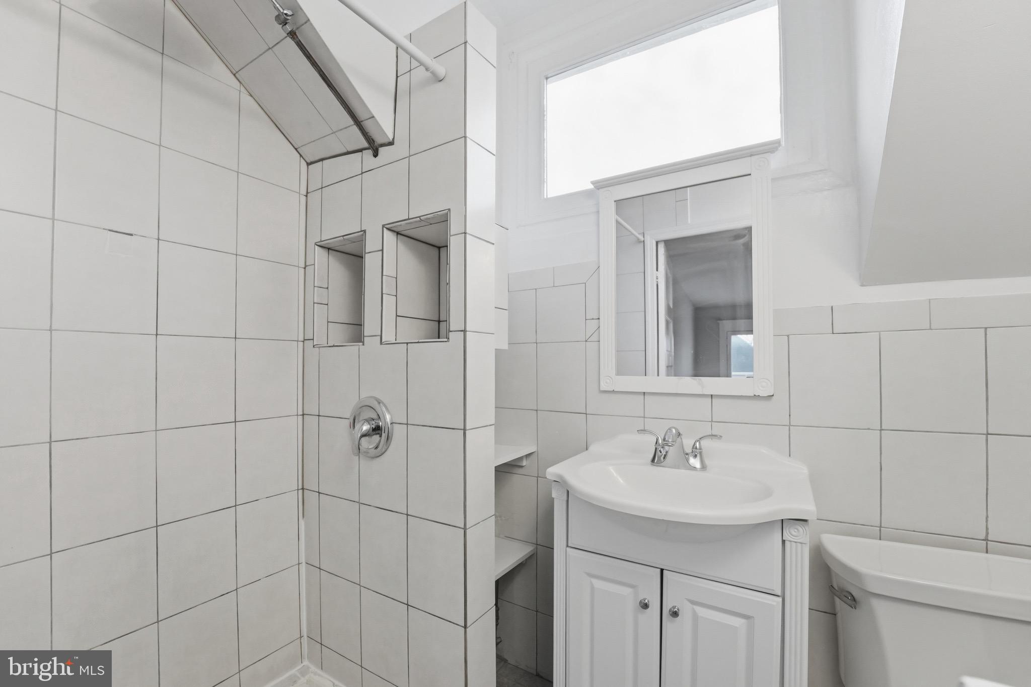 1310 Emerson Street Northwest Washington, DC 20011 - Photo 31 of 38 a bathroom with a sink shower and a mirror