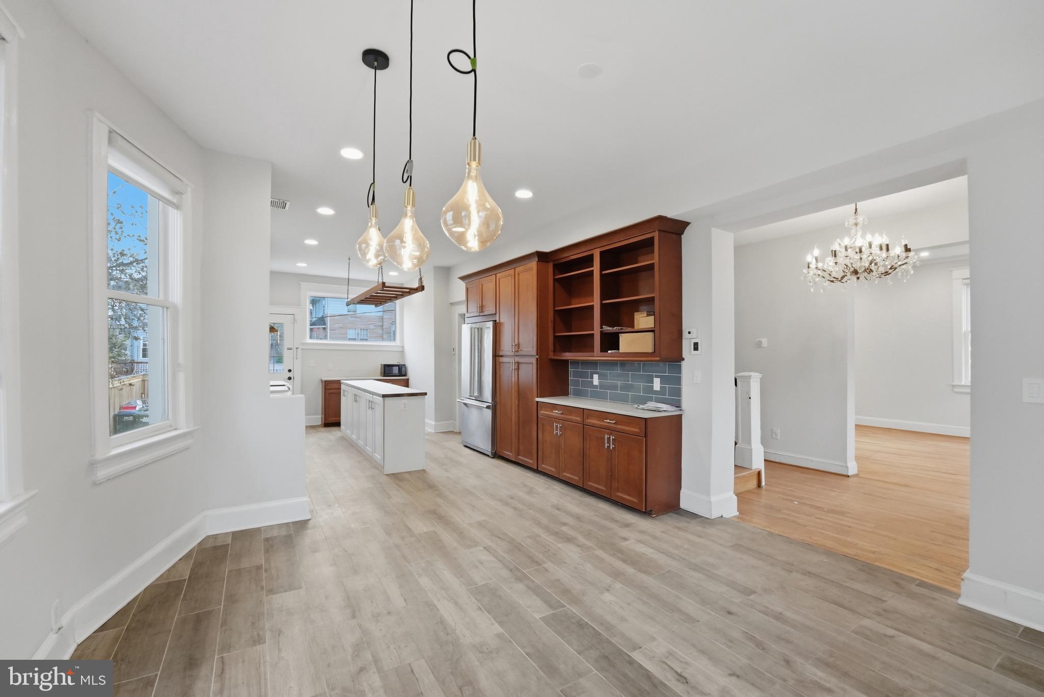 1310 Emerson Street Northwest Washington, DC 20011 - Photo 5 of 38 a open kitchen with stainless steel appliances granite countertop a refrigerator a stove and a wooden floors