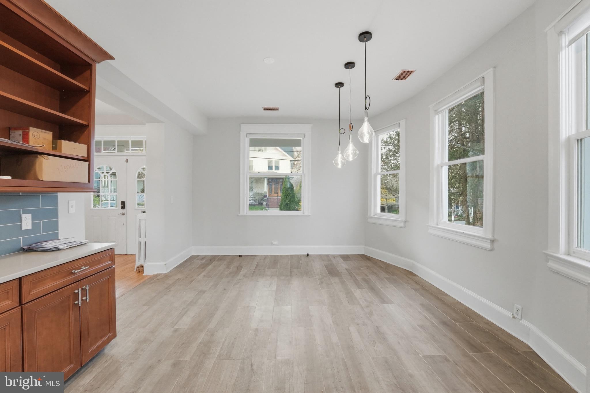 1310 Emerson Street Northwest Washington, DC 20011 - Photo 9 of 38 a view of an empty room with window and wooden floor
