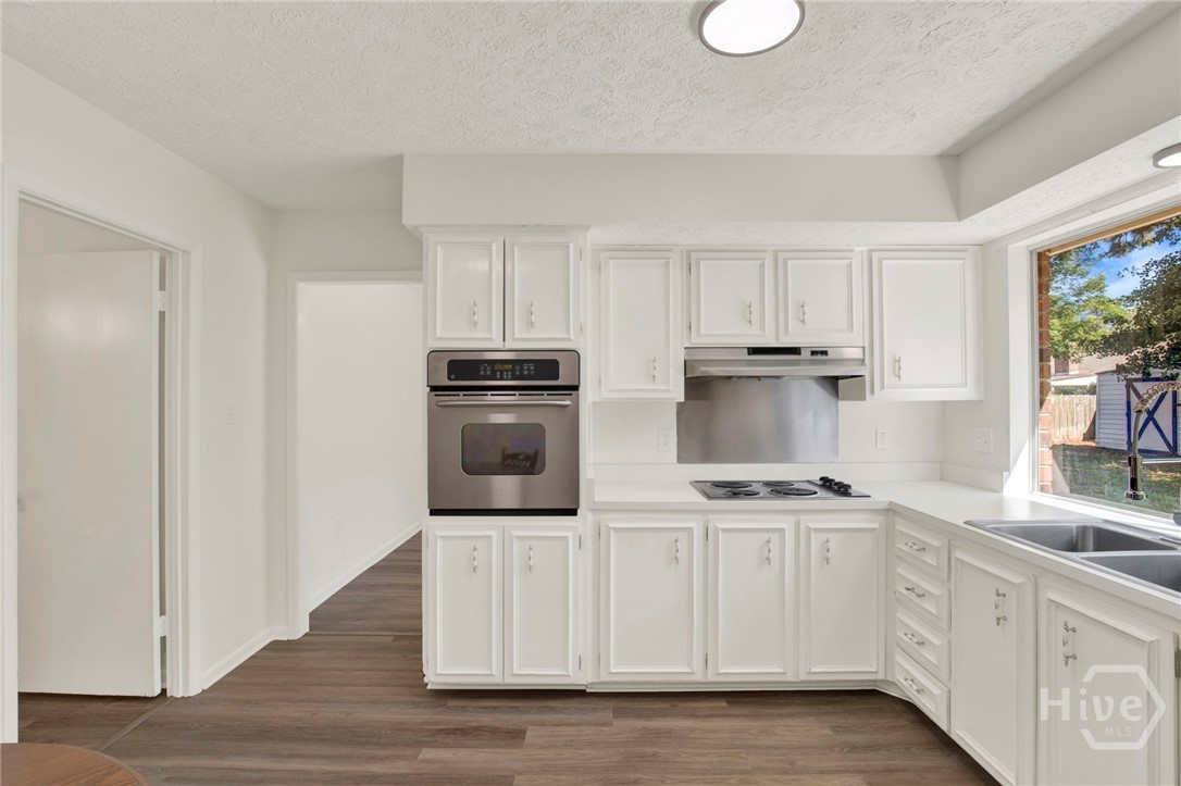 910 Old Mill Road Savannah, GA 31419 - Photo 10 of 41 Equipped kitchen featuring wood cabinetry and new light fixtures