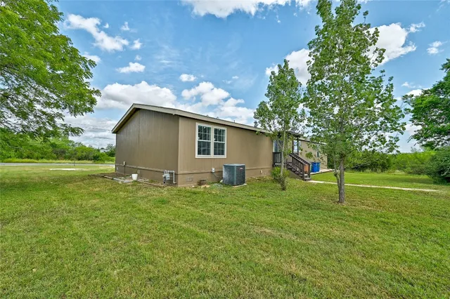 a backyard of a house with lots of green space