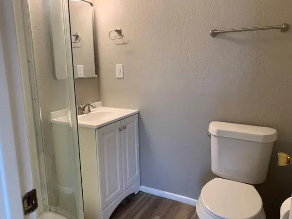 a white toilet sitting next to a bathroom sink