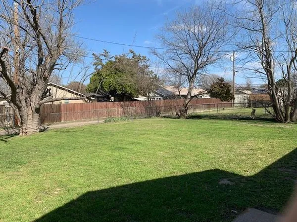 a view of a field of grass and trees