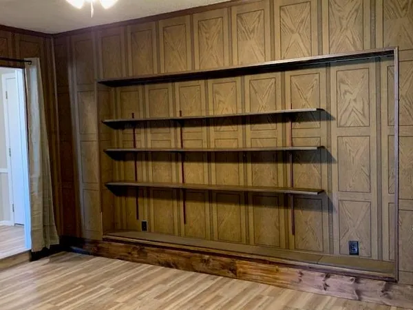 a view of a black door and wooden floor