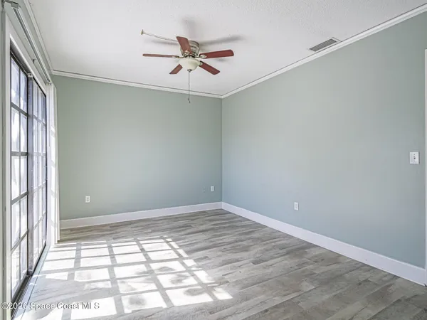 wooden floor in an empty room with a window