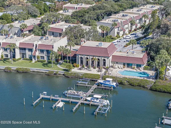 an aerial view of residential houses with outdoor space and lake view