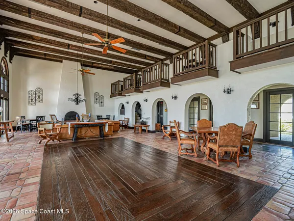 a living room with fireplace furniture and a wooden floor
