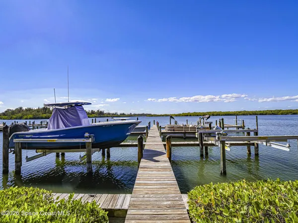 a view of a balcony with chairs and wooden floor