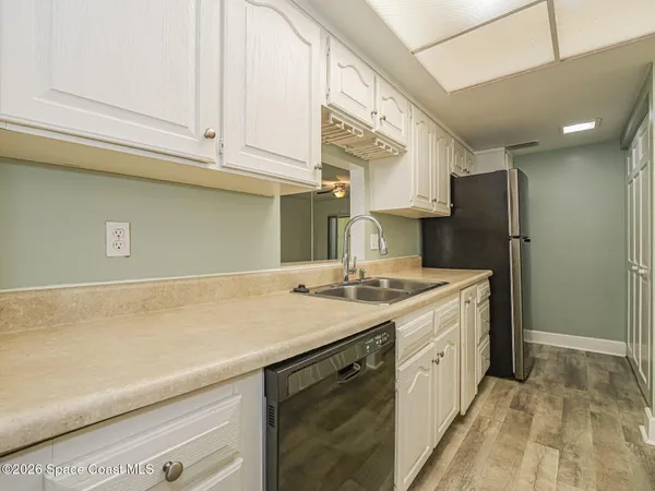 a kitchen with a sink cabinets and appliances