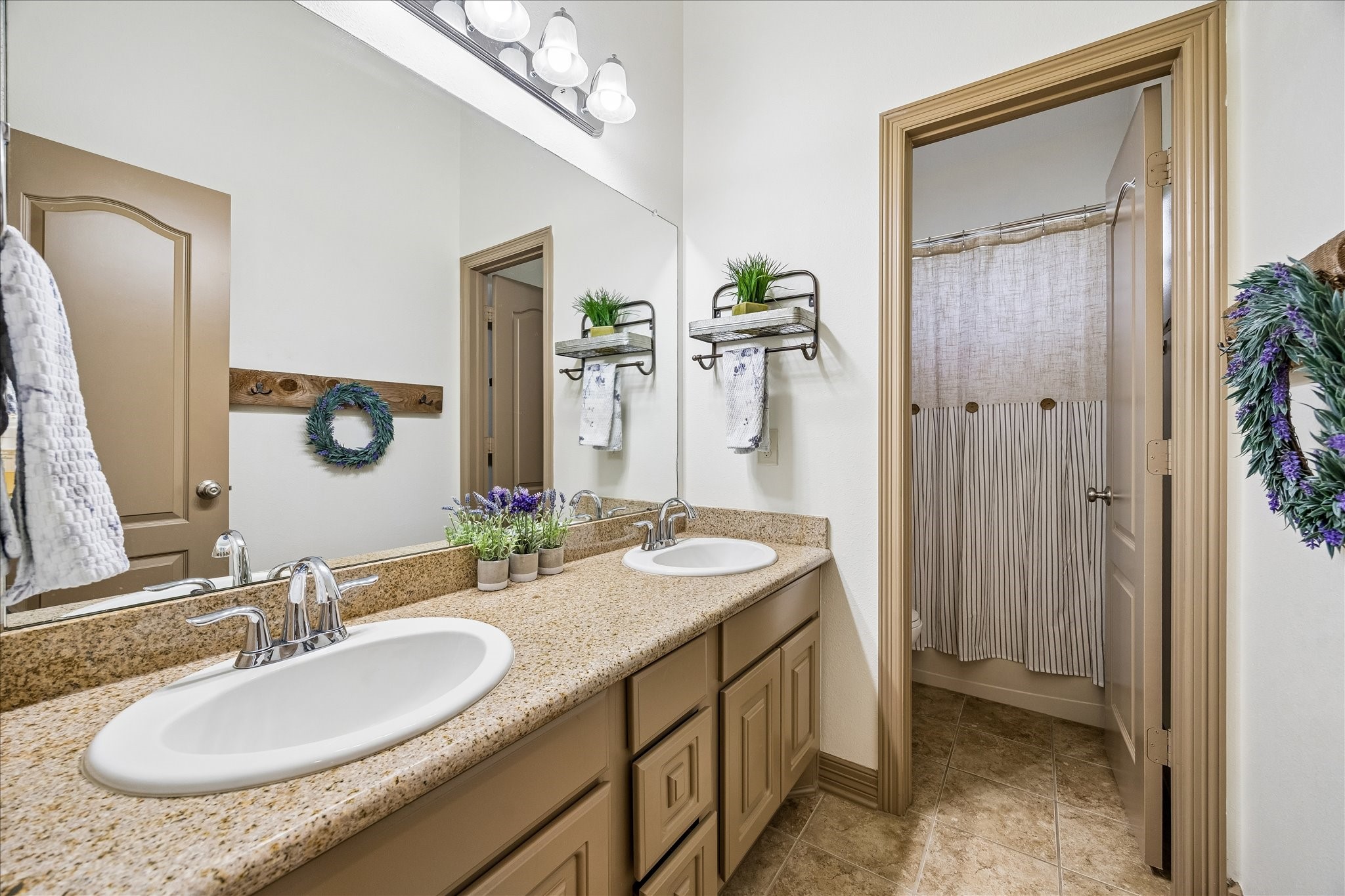 28211 Rippling Brook Lane Fulshear, TX 77441 - Photo 25 of 45 a bathroom with a granite countertop sink and a mirror