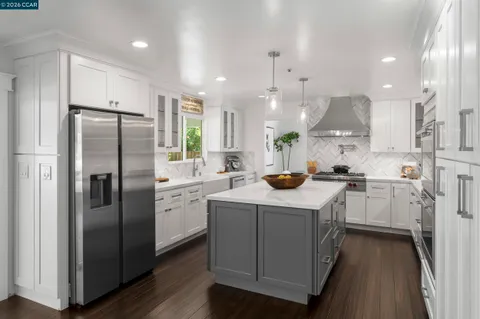 a dining hall with stainless steel appliances kitchen island granite countertop furniture and a view of kitchen
