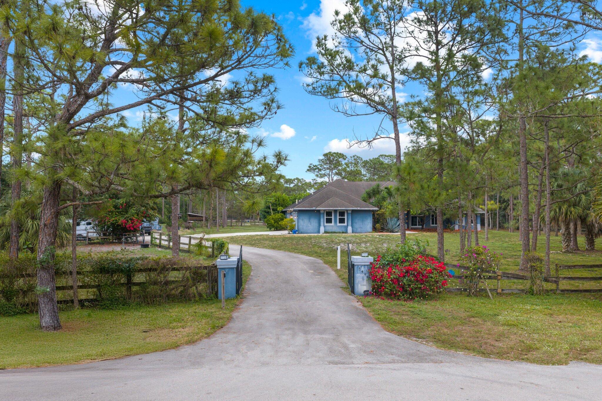 5446 Duckweed Road Lake Worth, FL 33449 - Photo 1 of 1 a view of a house with swimming pool and a yard