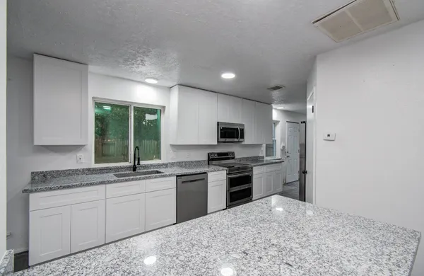 a kitchen with a sink stove and refrigerator
