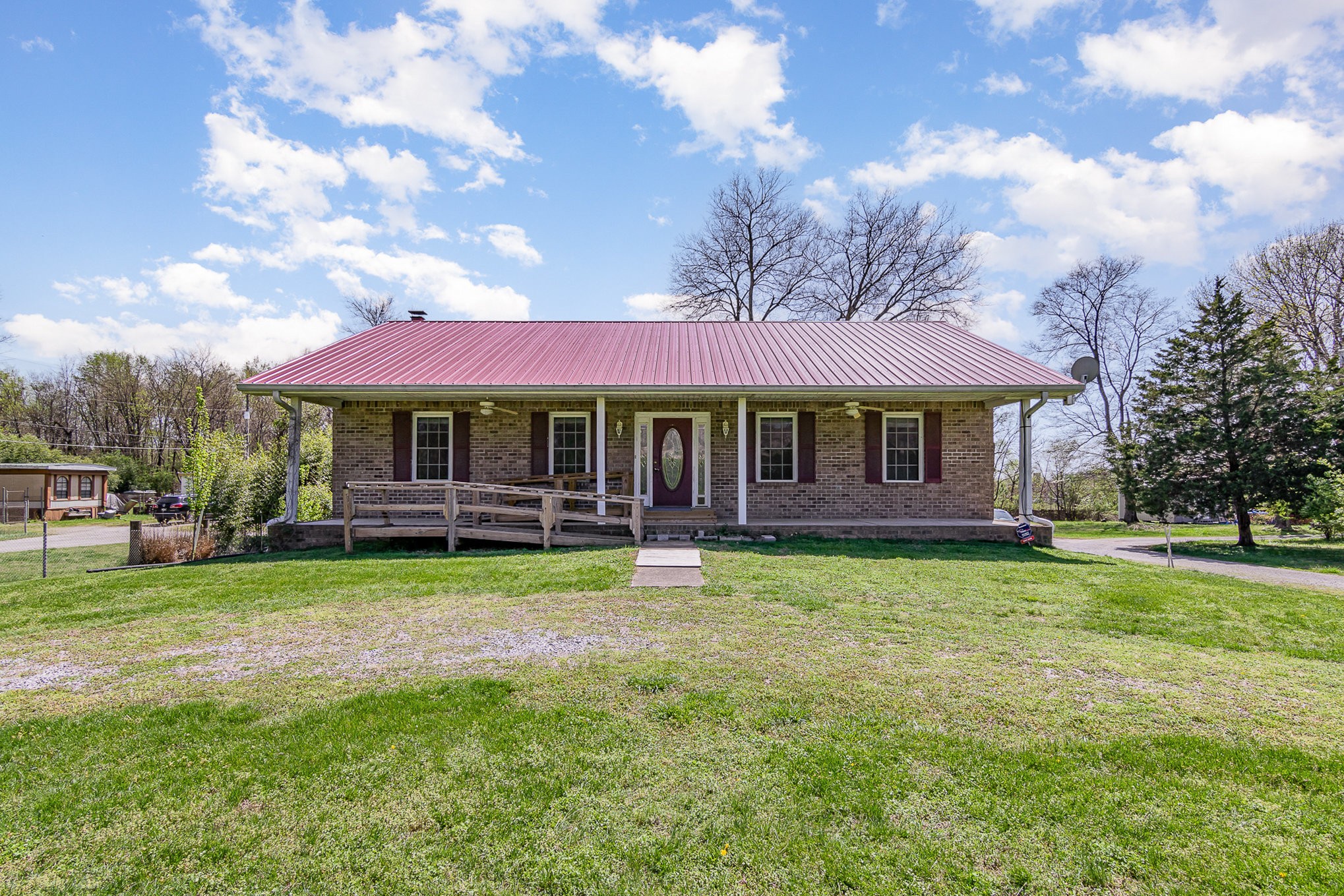 a front view of a house with swimming pool having outdoor seating