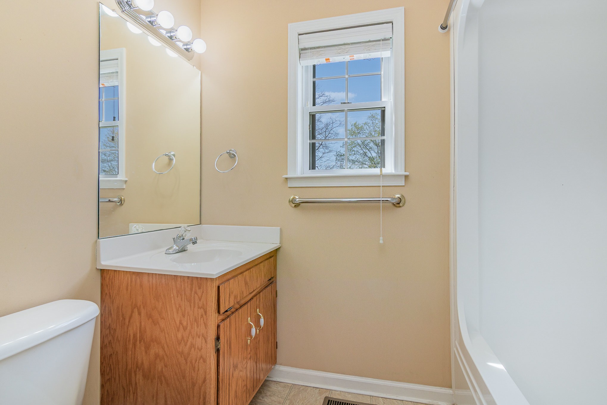 2575 Whitfield Road Clarksville, TN 37040 - Photo 13 of 30 a bathroom with a sink a toilet and a mirror