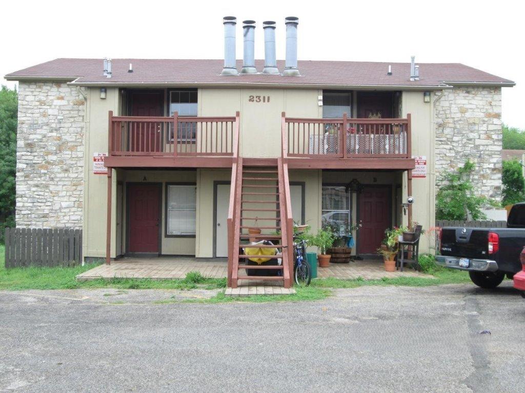 a front view of a house with a garden and plants