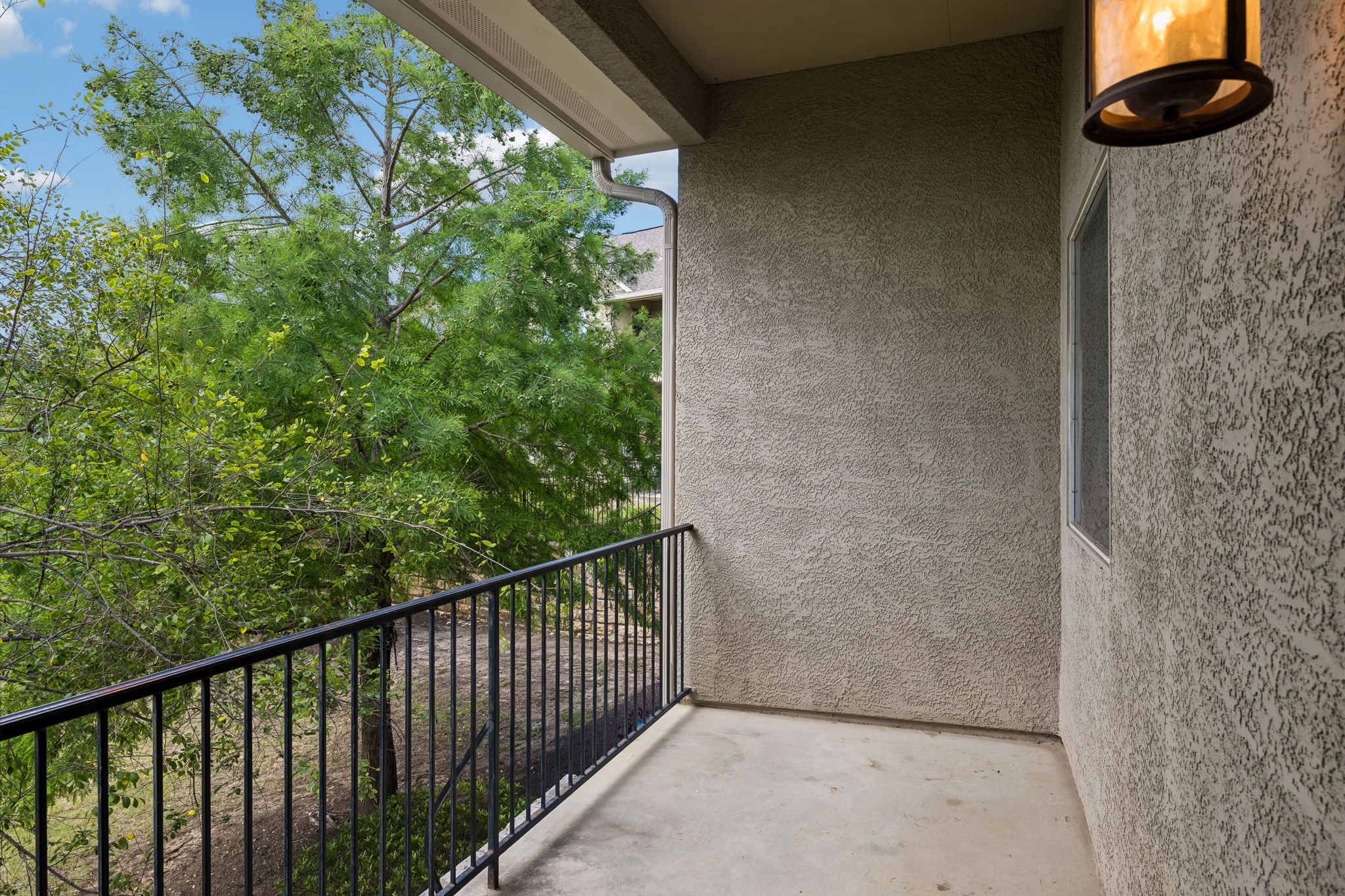 114 Aria Ridge, Unit 802 Lakeway, TX 78738 - Photo 31 of 37 A tranquil covered balcony overlooking verdant trees provides a serene outdoor escape.