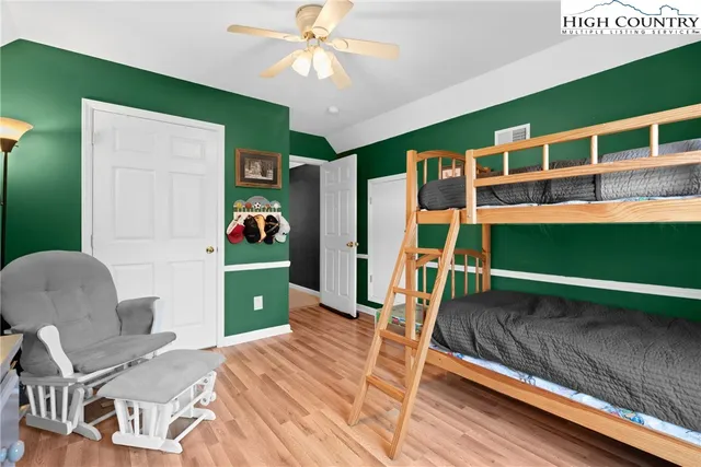 a bedroom with a bed and a bookshelf