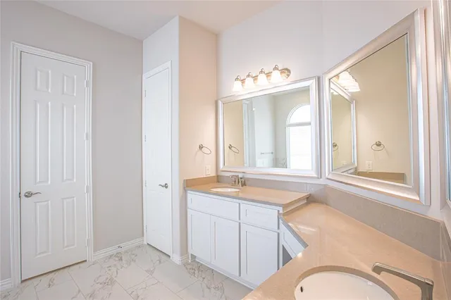 a bathroom with a sink a vanity and a mirror