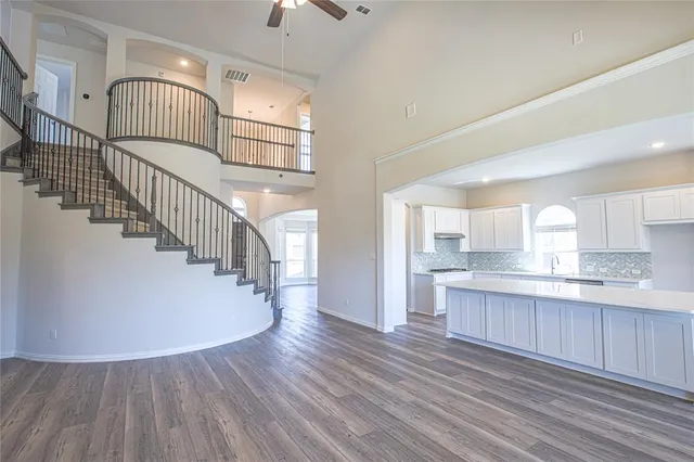 a view of kitchen with wooden floor and electronic appliances