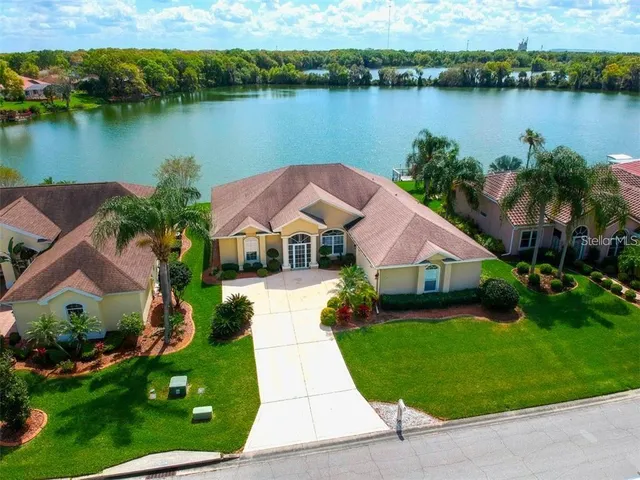an aerial view of house with yard and lake