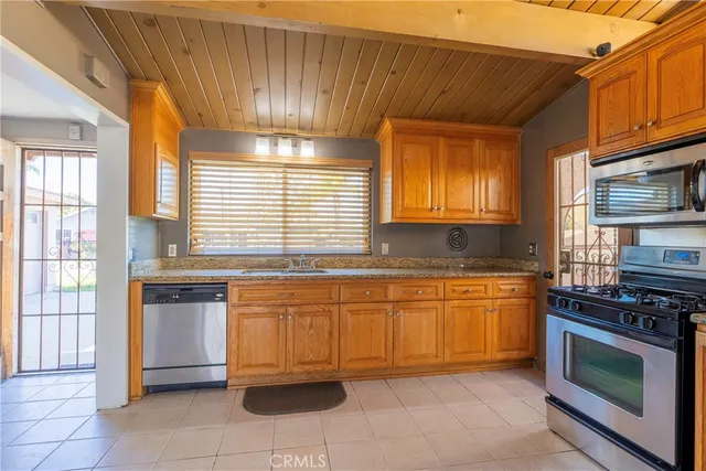 a kitchen with stainless steel appliances granite countertop a stove and a sink