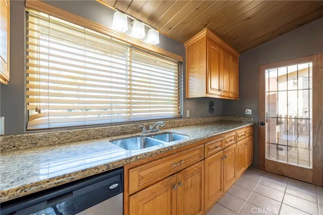a kitchen with granite countertop a sink and a window
