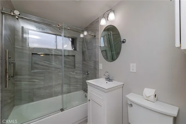 a bathroom with a sink mirror and shower