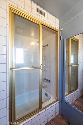 a bathroom with a shower and a tub