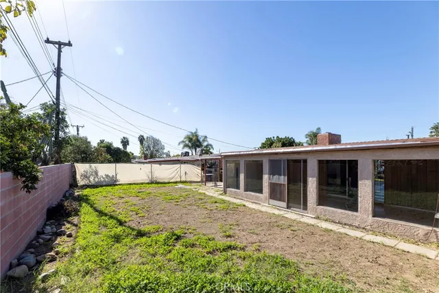 a view of a house with swimming pool and a yard