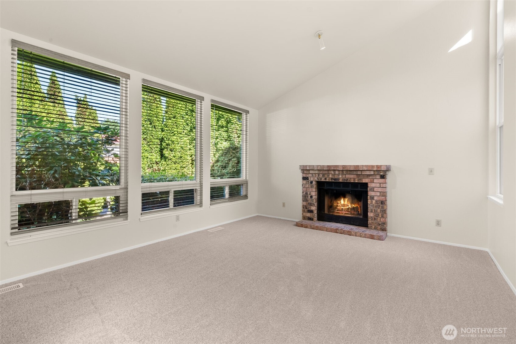 13603 Southeast 239th Street Kent, WA 98042 - Photo 3 of 23 a view of an empty room with a fireplace and a window