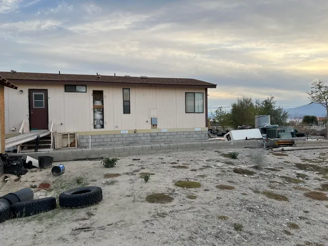 a backyard of a house with table and chairs