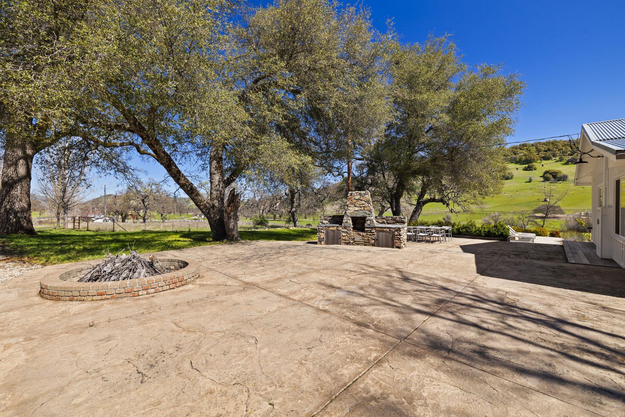 514 Appaloosa Road Angels Camp, CA 95222 - Photo 43 of 57 Large Stamped Concrete Patio for Entertaining with Firepit and Outdoor Stone Wood Burning BBQ
