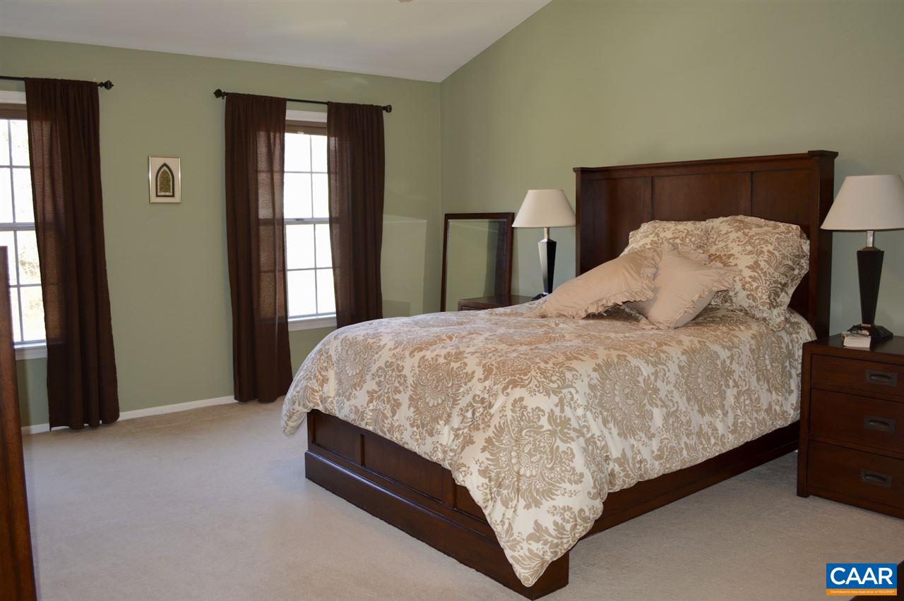 1167 Raintree Drive Charlottesville, VA 22901 - Photo 12 of 24 a bed sitting in a bedroom next to a window and dresser