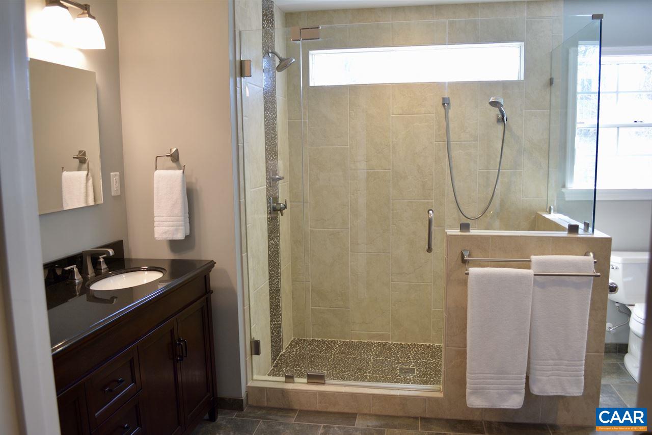 1167 Raintree Drive Charlottesville, VA 22901 - Photo 13 of 24 a bathroom with a granite countertop sink a mirror and a shower