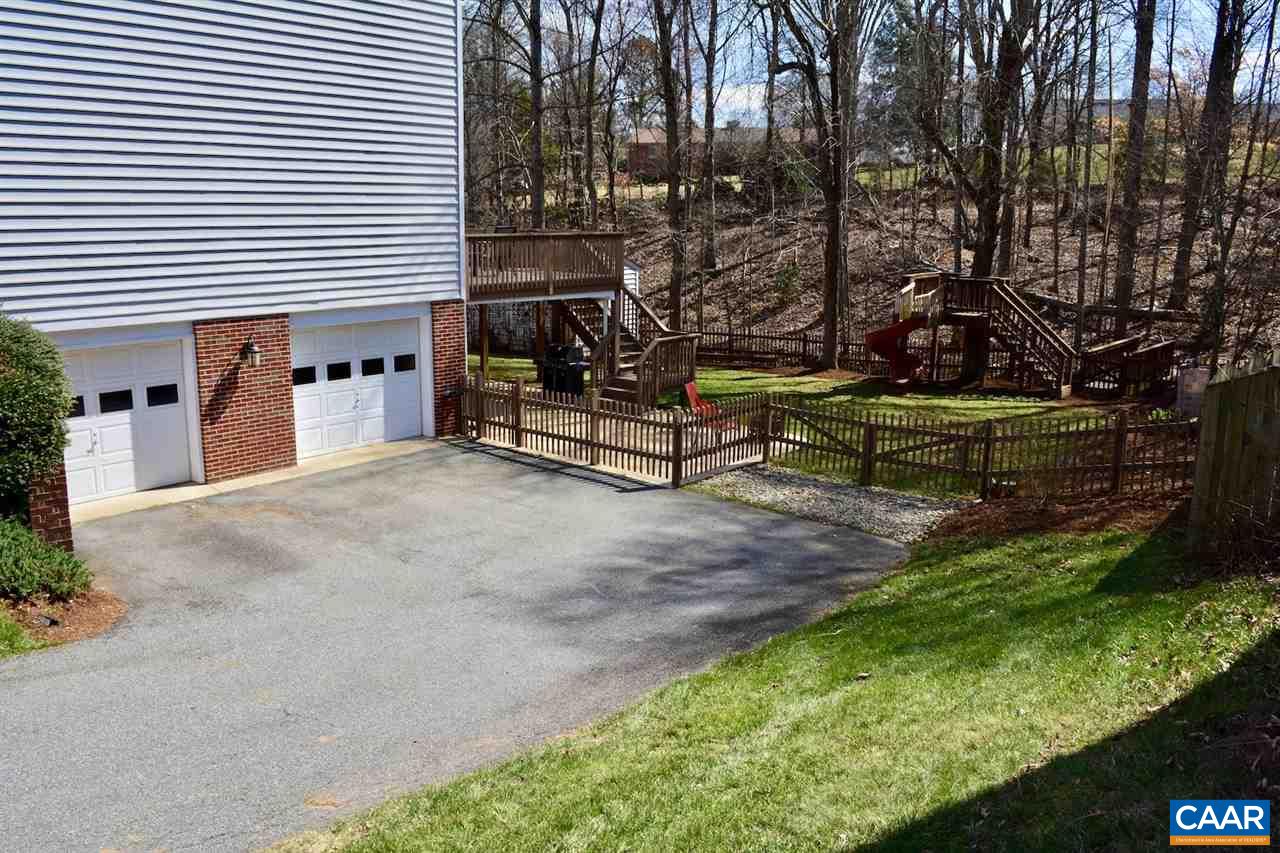 1167 Raintree Drive Charlottesville, VA 22901 - Photo 2 of 24 a view of a backyard with plants and a slide