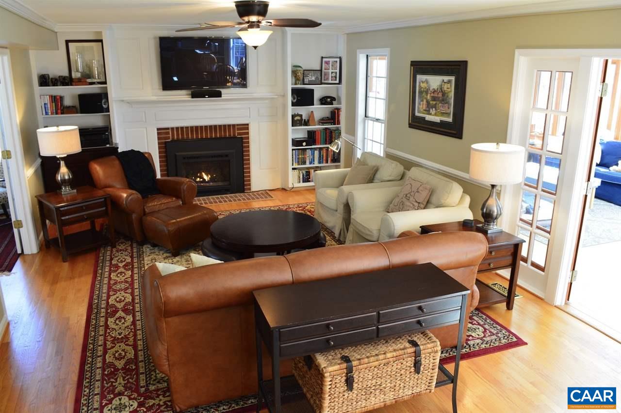 1167 Raintree Drive Charlottesville, VA 22901 - Photo 7 of 24 a living room with furniture a flat screen tv and a fireplace