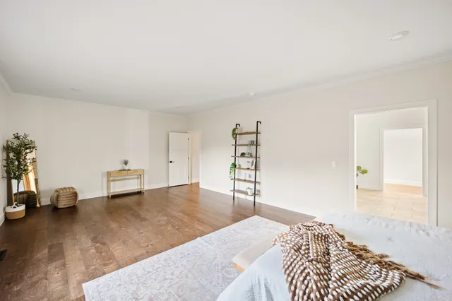 a bedroom with a bed and a chair