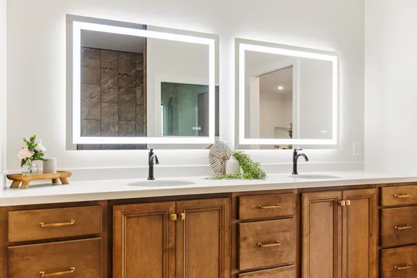 a bathroom with a double vanity sink and a mirror