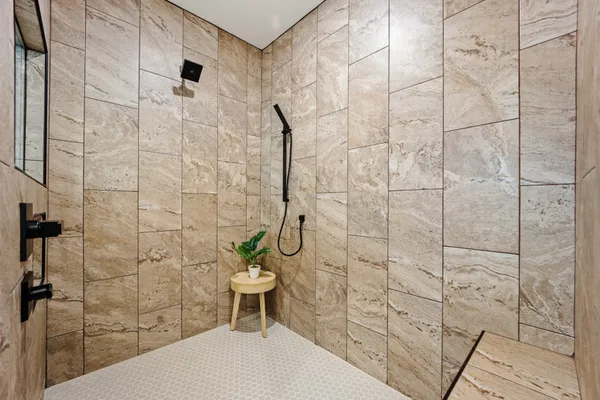 a bathroom with a toilet and a shower