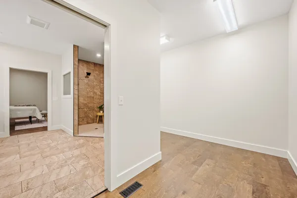 an empty room with closet and a bathroom