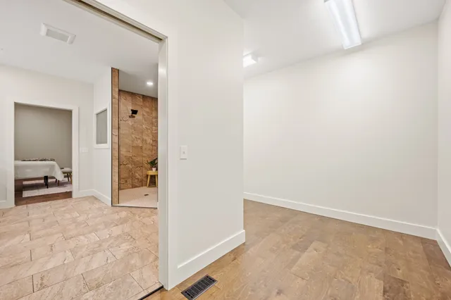 an empty room with closet and a bathroom